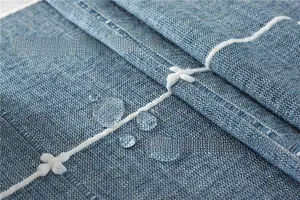 Macro shot of waterproof navy jacquard tablecloth fabric with white grid stitching