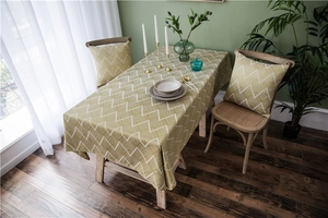 Waterproof olive green chevron tablecloth with matching cushions in a Nordic home setting