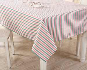 Close-up detail of multi-color striped cotton tablecloth with red and white vertical patterns