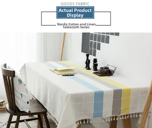 Detail of Nordic linen tablecloth with blue and yellow stripes and tassel edge