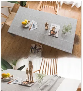 Close-up of vintage grey faux linen tablecloth with embroidered checks and tassel trim