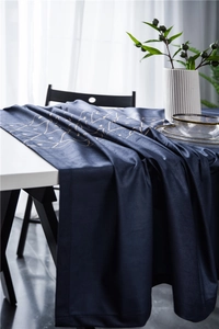 Close-up of luxury dark blue velvet tablecloth with gold geometric lines and soft drape