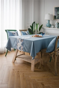 Detail of waterproof polyester linen table runner with floral pattern and matching cushion