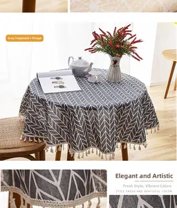 Detail of dark grey Nordic round tablecloth with white chevron pattern and tassel edges