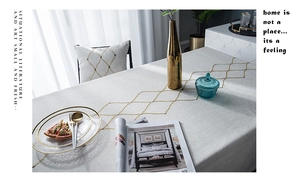 Macro detail of geometric gold diamond embroidery on waterproof modern linen tablecloth