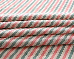 Close-up of red, green and white striped poly-cotton fabric with clear woven texture