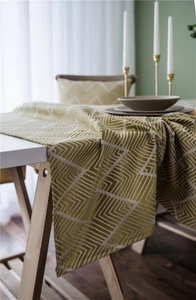 Detail view of woven table runner featuring yellow and white geometric maze patterns