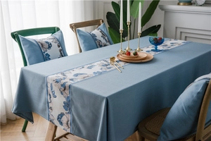 Close-up of waterproof faux linen tablecloth with elegant blue floral table runner pattern