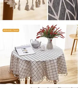 Macro detail of white checkered cotton tablecloth with beige woven tassel fringe