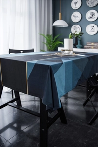 Detail of luxury velvet tablecloth with geometric navy patterns and gold fashion lettering