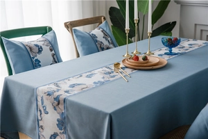 Close-up of light blue faux linen table runner with elegant floral jacquard pattern