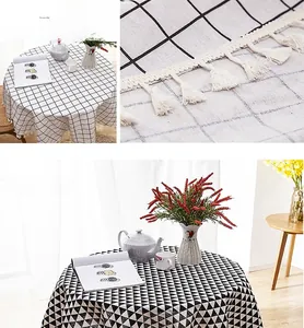 Detail of Nordic linen-textured tablecloth with black geometric print and fringe tassels