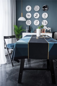 Detail of luxury geometric velvet tablecloth with blue-black tones and gold faith text