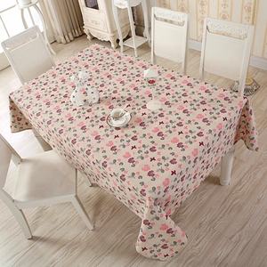 Close-up of rectangle tablecloth with pink clover and butterfly patterns in rustic style
