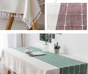 Detailed view of striped linen tablecloth showing exquisite white fringe and grid patterns