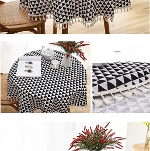 Detail of Nordic round tablecloth featuring grey geometric triangles and white fringe edges