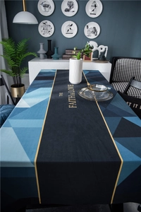 Detail showing plush geometric table runner with gold accents and printed typography