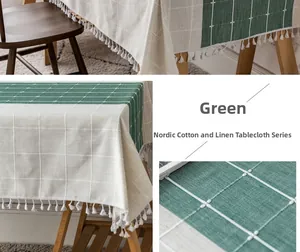 Detail of green and beige checkered cotton linen tablecloth with fringe edges in a cozy room