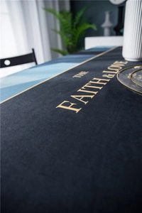 Detail of luxury velvet tablecloth with golden geometric patterns and text printing