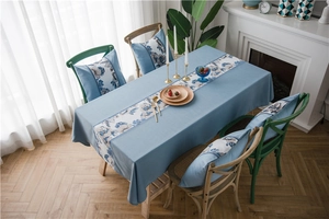 Close-up of waterproof faux linen table runner with elegant blue floral stone painting