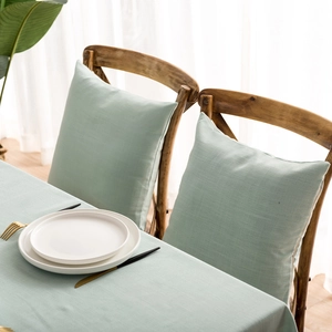 Detail of mint green waterproof tablecloth and matching cushions in minimalist Nordic style
