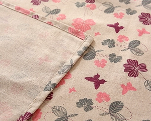 Detail of printed cotton linen tablecloth showing fine stitching and floral patterns