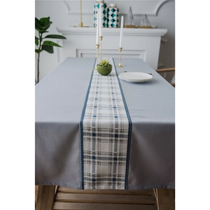 Waterproof faux linen table runner with geometric diamond pattern on wooden dining table