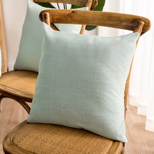 Detail of mint green linen texture cushion cover with natural fabric grain and rustic decor