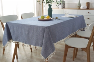 Detail of blue cotton linen tablecloth showing thick texture and white fringe tassels