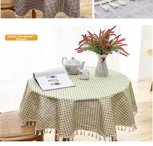 Close-up of green and white checkered tablecloth with decorative white fringe tassels