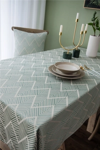 Detail of waterproof geometric wave jacquard fabric on a modern grey-green rectangular tablecloth