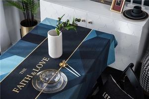 Close-up of luxury velvet tablecloth with geometric patterns and gold lettering