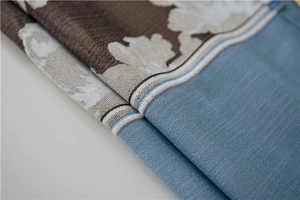 Detailed macro view of sky blue and dark brown floral faux linen waterproof fabric texture