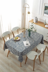Close-up of blue and white geometric jacquard tablecloth with a natural cotton linen texture