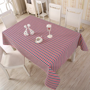 Detail of red and blue striped rectangular tablecloth on a white wooden table