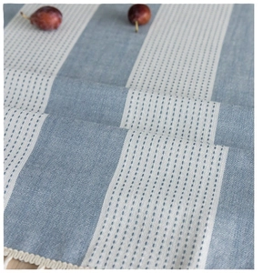 Blue and white striped linen tablecloth with decorative fringe and wavy tassel borders