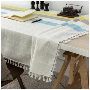 Nordic plaid linen tablecloth with colorblock stripes and fringe on wooden table