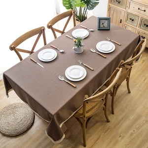 Waterproof dark brown rectangular tablecloth with white lace edges on a wooden dining table