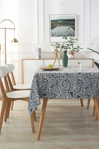 Detail of waterproof tablecloth featuring navy geometric triangles on beige fabric