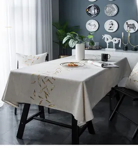 Detail of waterproof cotton-linen tablecloth with elegant golden leaf embroidery pattern