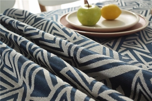 Close-up of waterproof dark blue geometric jacquard fabric with soft folding texture
