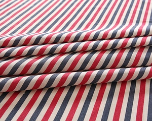 Detailed view of the woven fabric texture featuring red, navy, and beige stripes