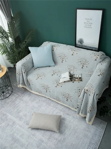 Detailed view of chenille sofa cover with floral pattern and elegant beige lace edging