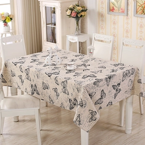 Detail of rectangular beige table cloth with black butterfly and vintage French stamps