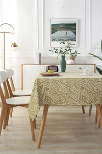 Close-up of waterproof jacquard tablecloth featuring green geometric triangle patterns