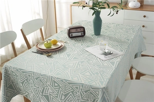 Detail of light green rectangular tablecloth with modern geometric triangle pattern texture