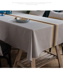 Detailed view of modern cotton linen tablecloth with embroidered geometric yellow stripes