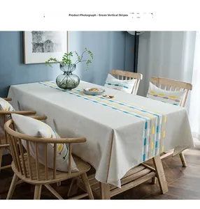 Detailed vertical embroidery stripes on a modern linen table runner with tassels