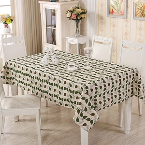 Detail of beige rectangle tablecloth with green leaf print on cotton linen blend fabric