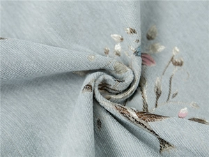 Close-up of thick chenille fabric with intricate leaf jacquard pattern and texture